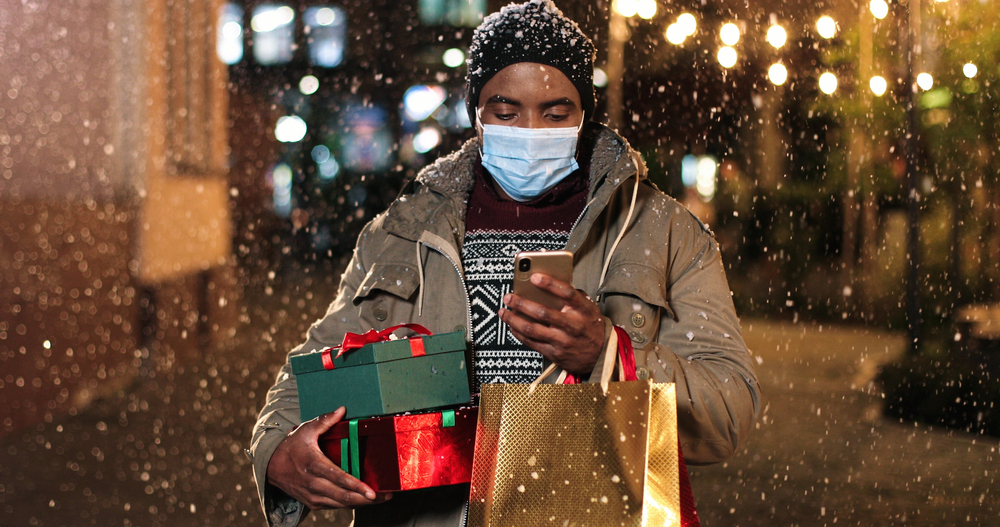 Man carrying holiday gifts.