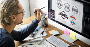 man designing logos on pc
